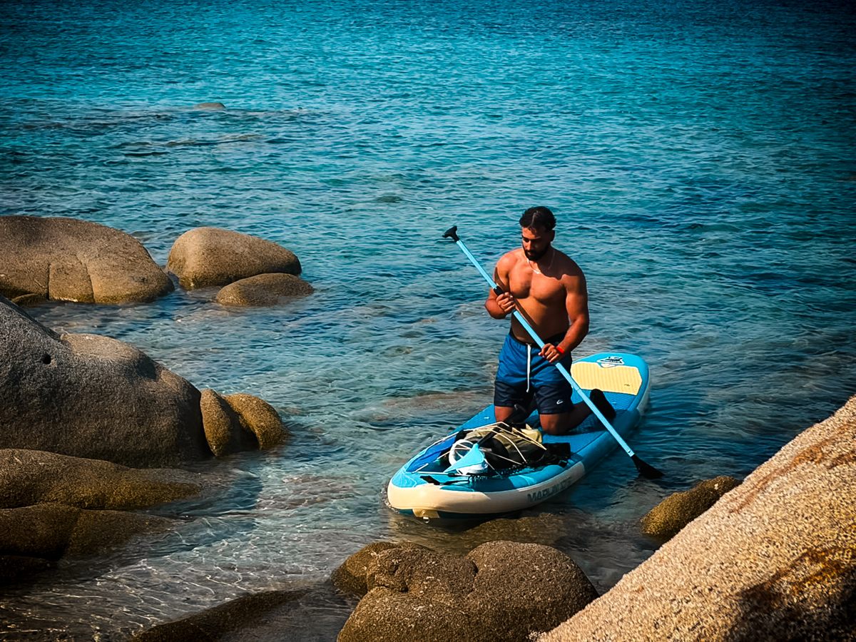 Adam on a paddle board among the rocks