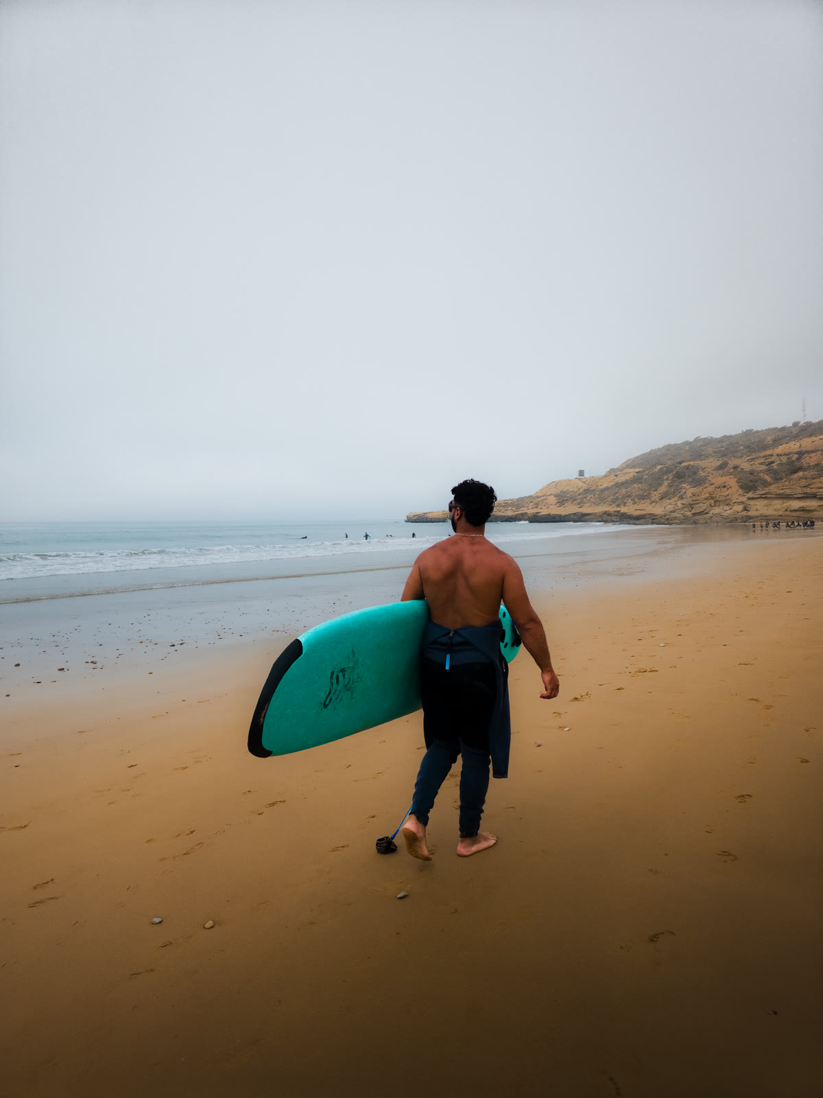 Adam walking into the surf