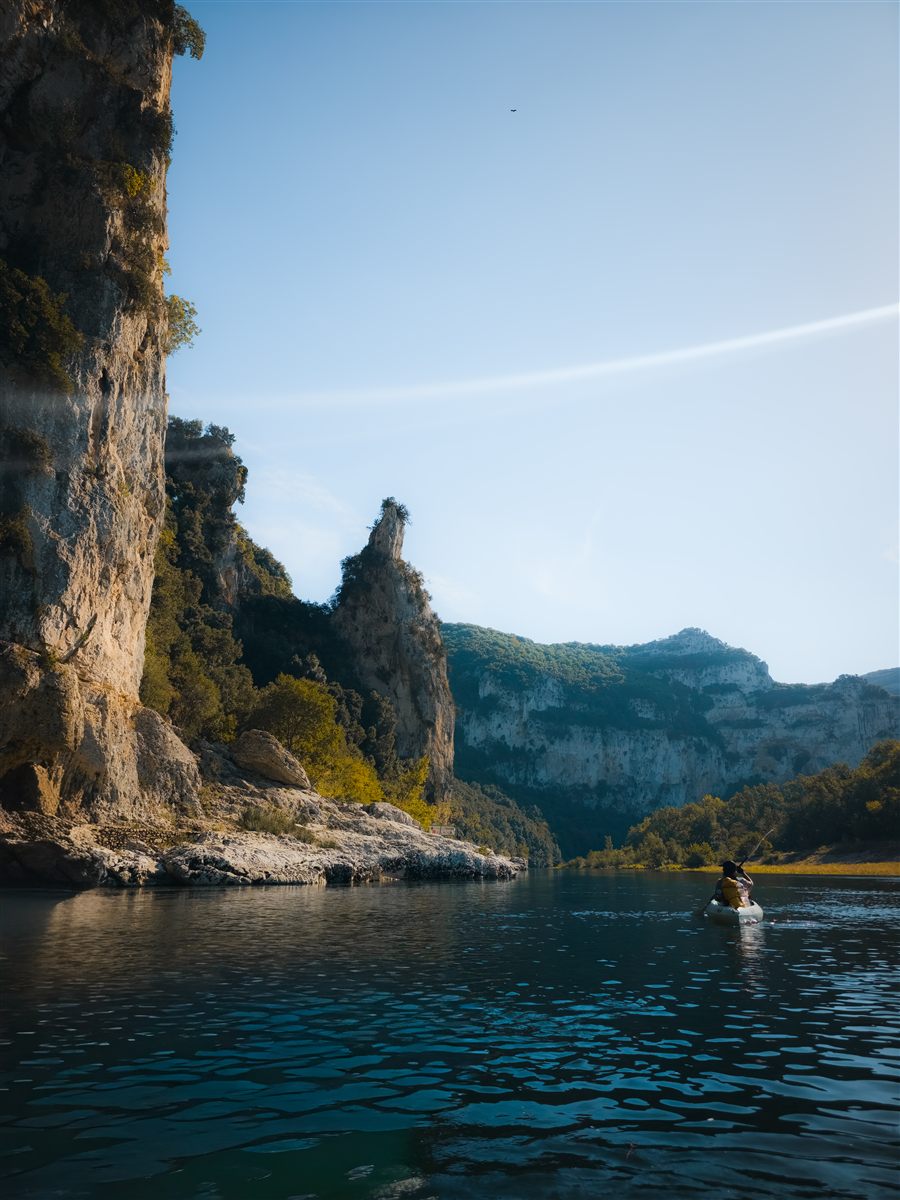 Kayak under a limestone cliff